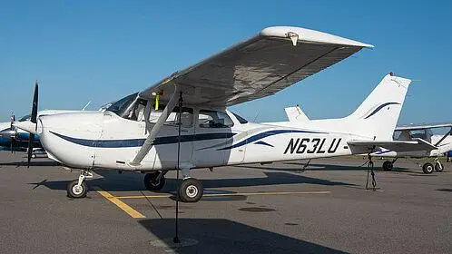 Student pilot planning a cross-country route in the PIC flight room